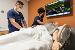 UF nursing students Serenity McNair and Jacob Zoltek use a high-fidelity patient simulator to learn and practice skills in the newly renovated Thomas M. and Irene B. Kirbo Innovation and Learning Laboratory.