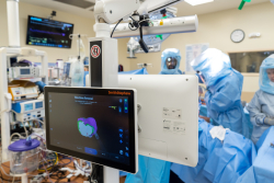 Computer screens allow surgeons to view a 3D image of the joint as they resect bone. (Photo by Jesse S. Jones)