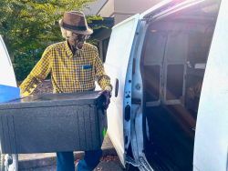 ElderCare of Alachua County volunteer Frank Turner, 88, loads meals for his Meals on Wheels route.