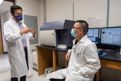 Dr. Liang Zhou speaks to his postdoctoral associate, Dr. Lifeng Xiong, in his laboratory. Xiong was first author on a recent paper published by the Zhou laboratory in Science Immunology relating to the protein Ahr.
