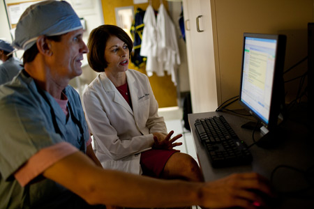 CTSI Personalized Medicine Program Director Julie A. Johnson and cardiologist R. David Anderson review an alert that appears in a cardiac patient’s electronic medical record when genetic results suggest a prescribed drug may not be effective. (Photo by Jesse Jones/University of Florida)