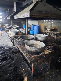 The prison kitchen at National Penitentiary in Port-au-Prince. Prisoners must provide their own plates or bowls, making standardized serving sizes difficult. Photos courtesy of Dr. Arch Mainous.