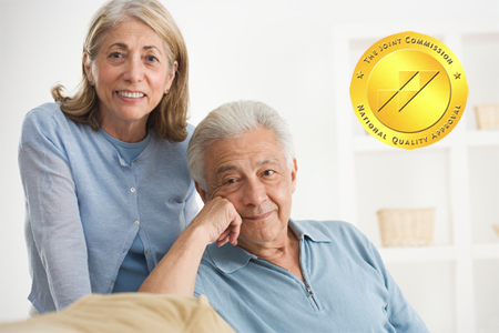 Couple smiling with joint commission seal.