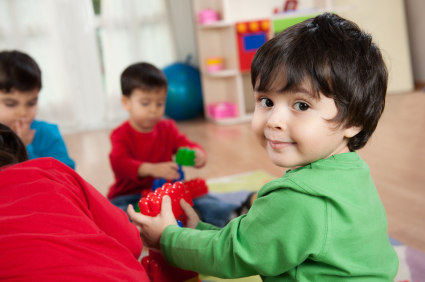 little boy playing with friends in a playroom