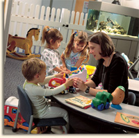 children playing in a Shands playroom with a volunteer