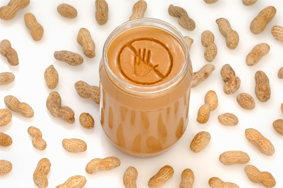 Jar of peanut butter and peanuts
