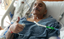 Rich Karam lying in a hospital bed at UF Health Shands Cancer Hospital.