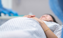 pregnant woman on laying hospital bed